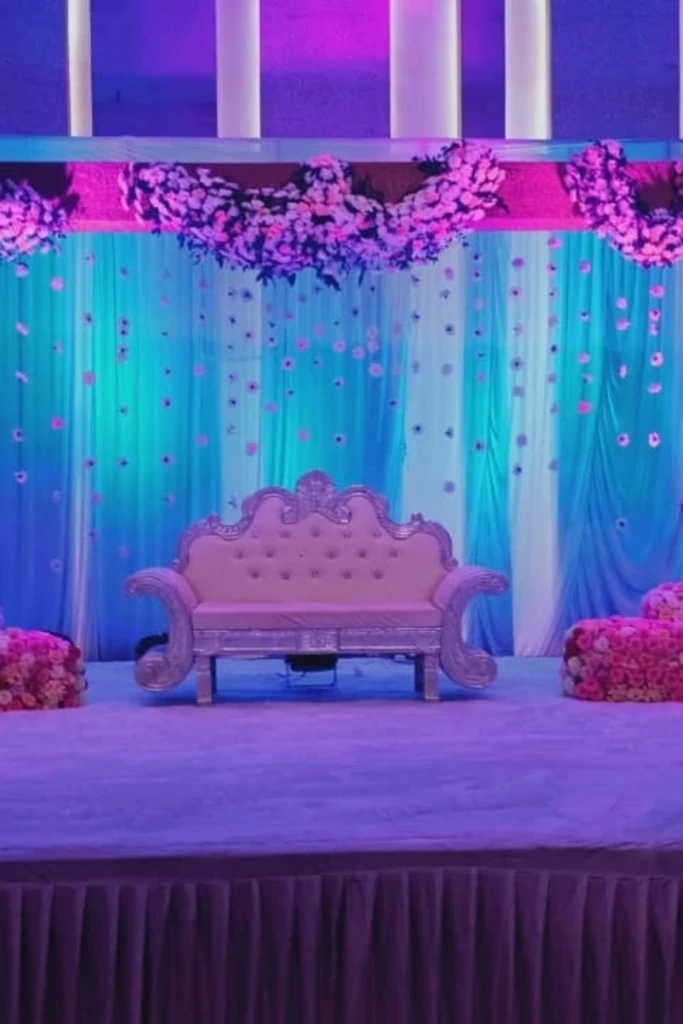 Elegant Stage with Draped Florals and Pastel Lighting