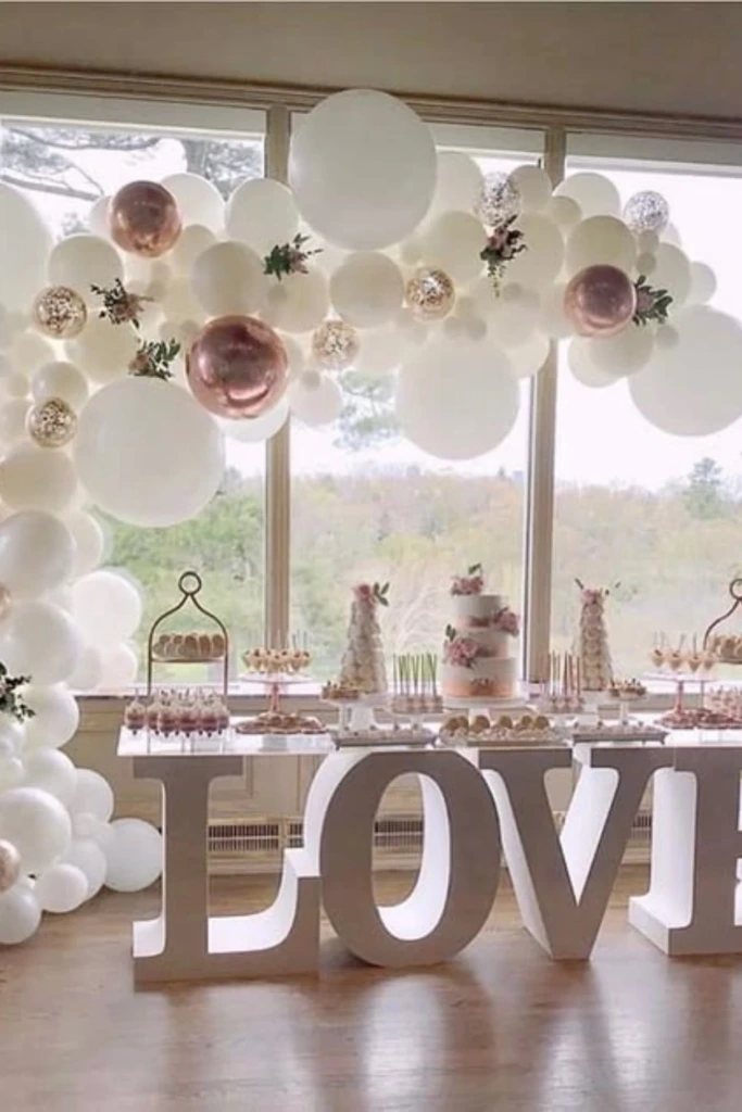 White and Rose-Gold Balloon Arch with LOVE Display