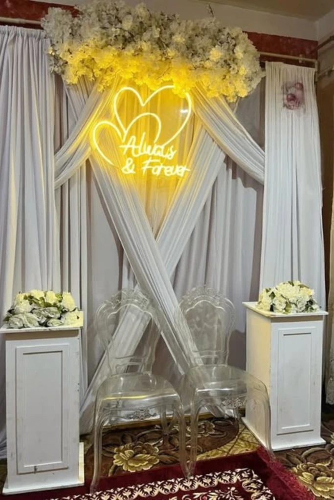 Intimate Neon Backdrop with Clear Seating