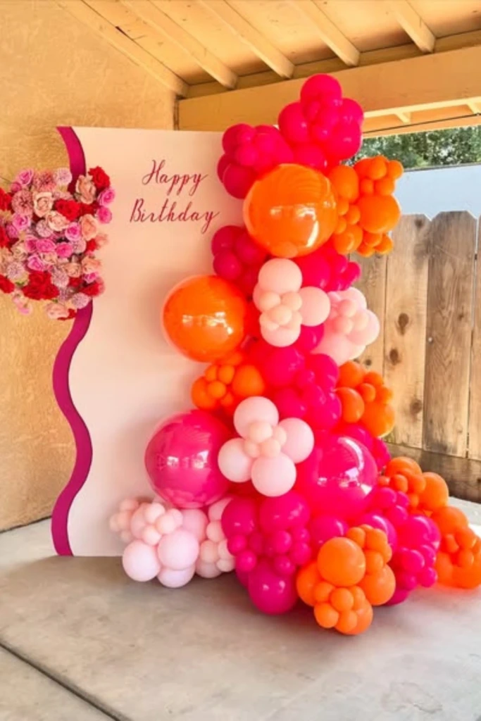 Bright Balloon Cascade with Floral Accent