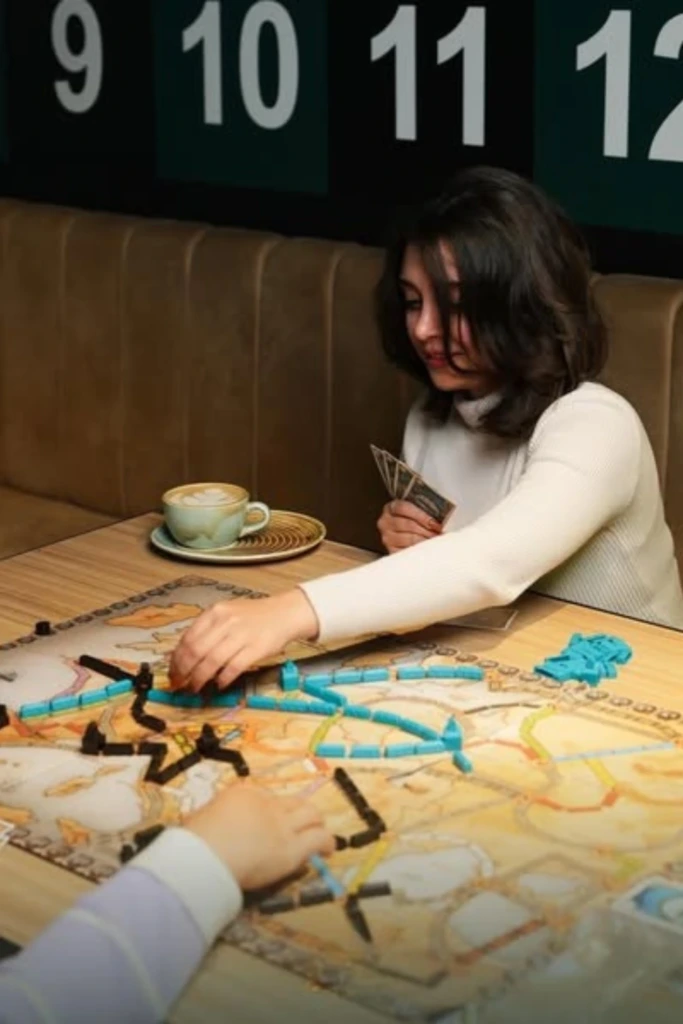 Ticket to Ride Strategy Under Warm Café Light