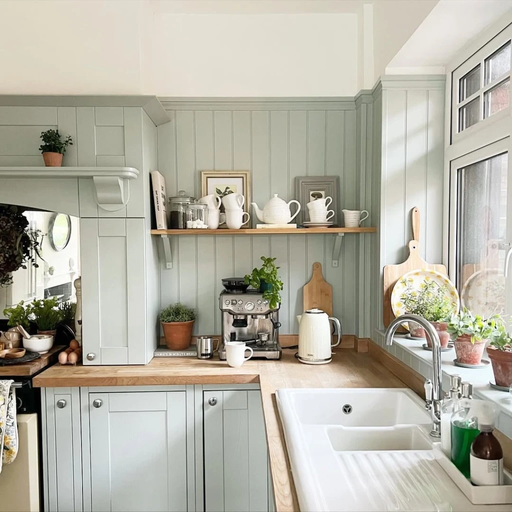 7. Soft Sage Kitchen with Minimal Open Shelf Display