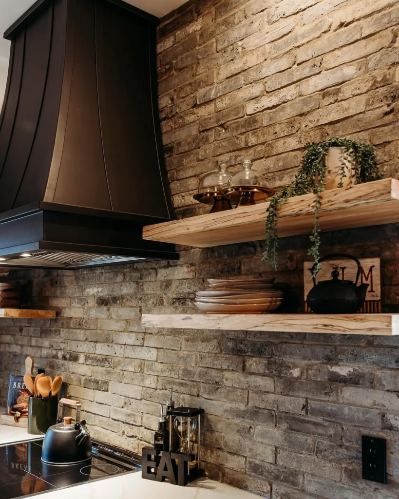 10. Moody Brick Kitchen with Floating Wooden Shelves