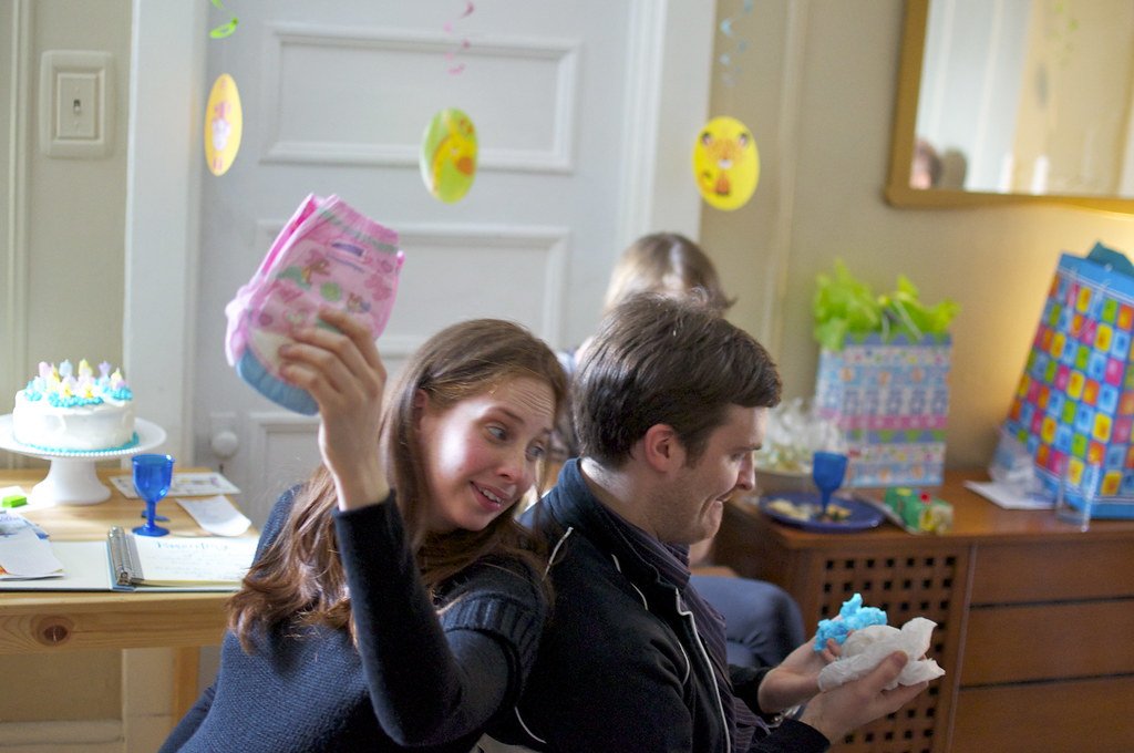 Guests playing baby bingo while gifts are opened